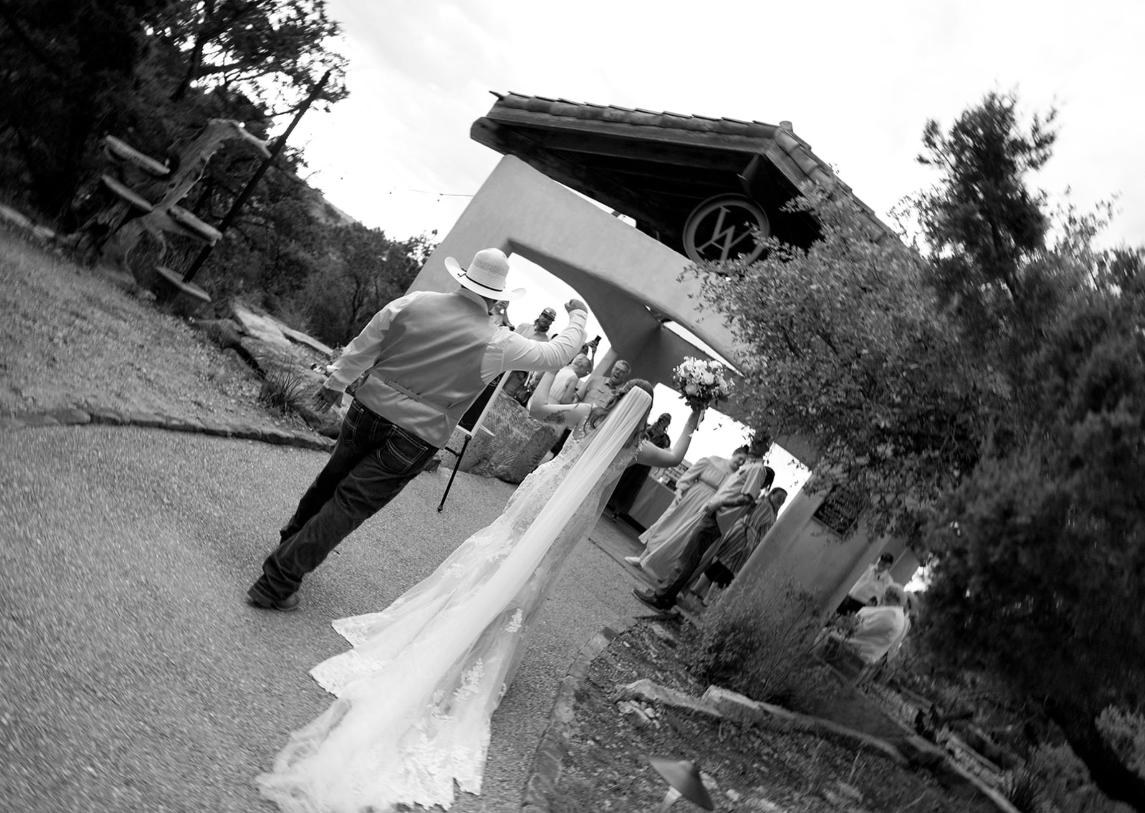 Bride and groom walking hand in hand toward their wedding party, celebrating together after the ceremony — captured by San Antonio wedding photographer Angie Rich.