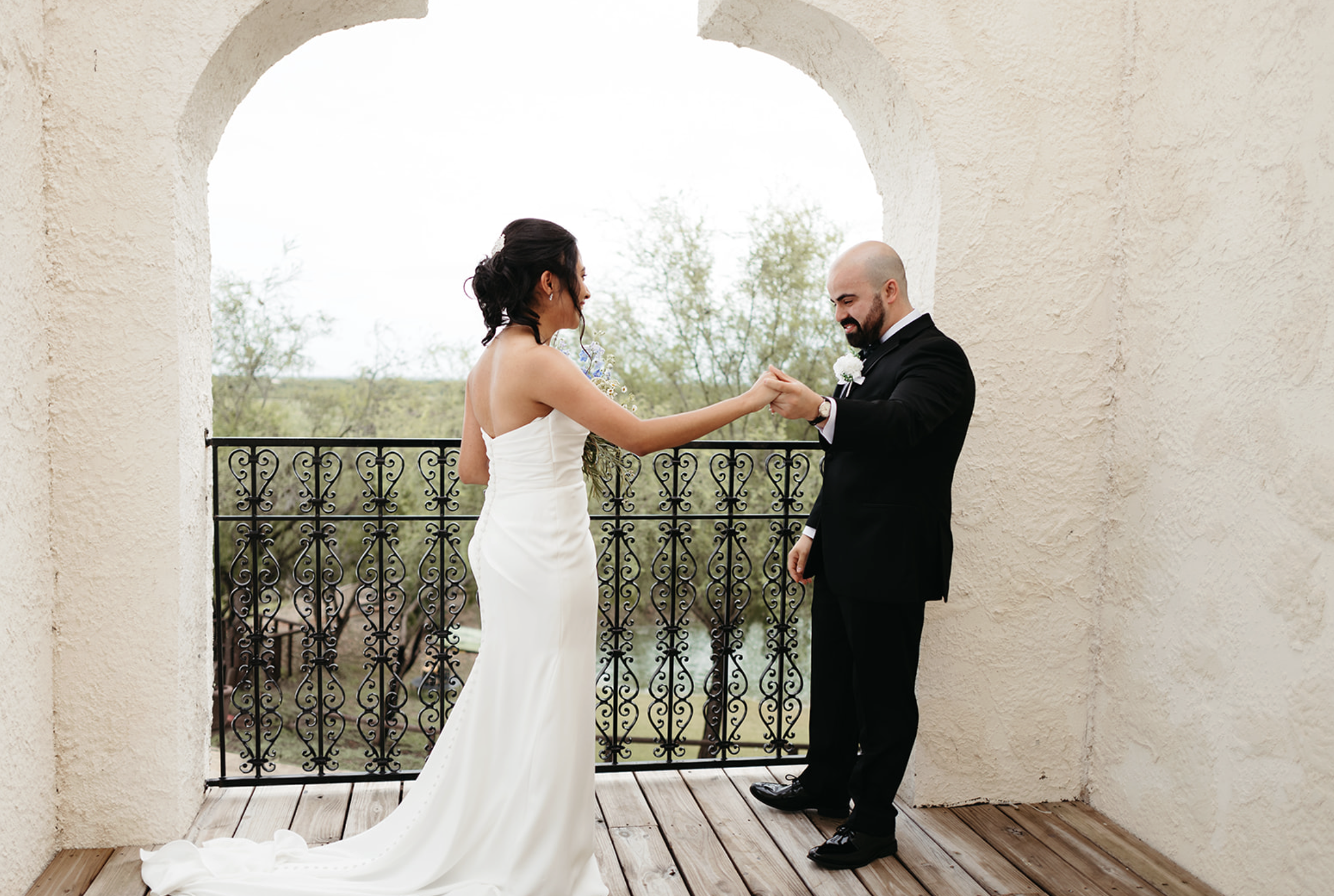 Groom tearing up as he sees his bride for the first time during their emotional first look, captured by San Antonio wedding photographer Angie Rich.