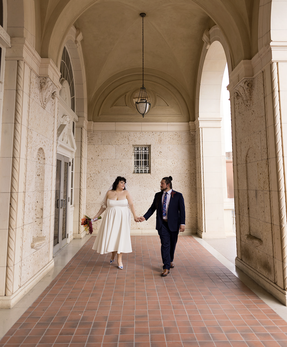 Couple laughing and holding hands during their San Antonio elopement photo session, captured by photographer Angie Rich.