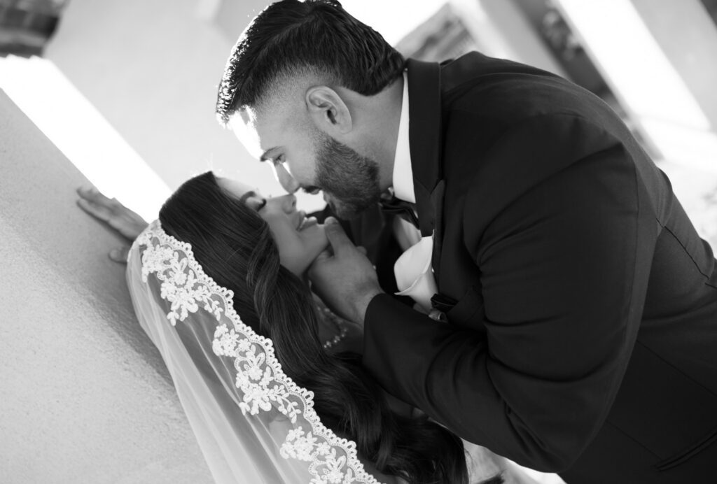 Black and white close-up of newlyweds sharing a romantic moment after their Chapel Dulcinea ceremony.
