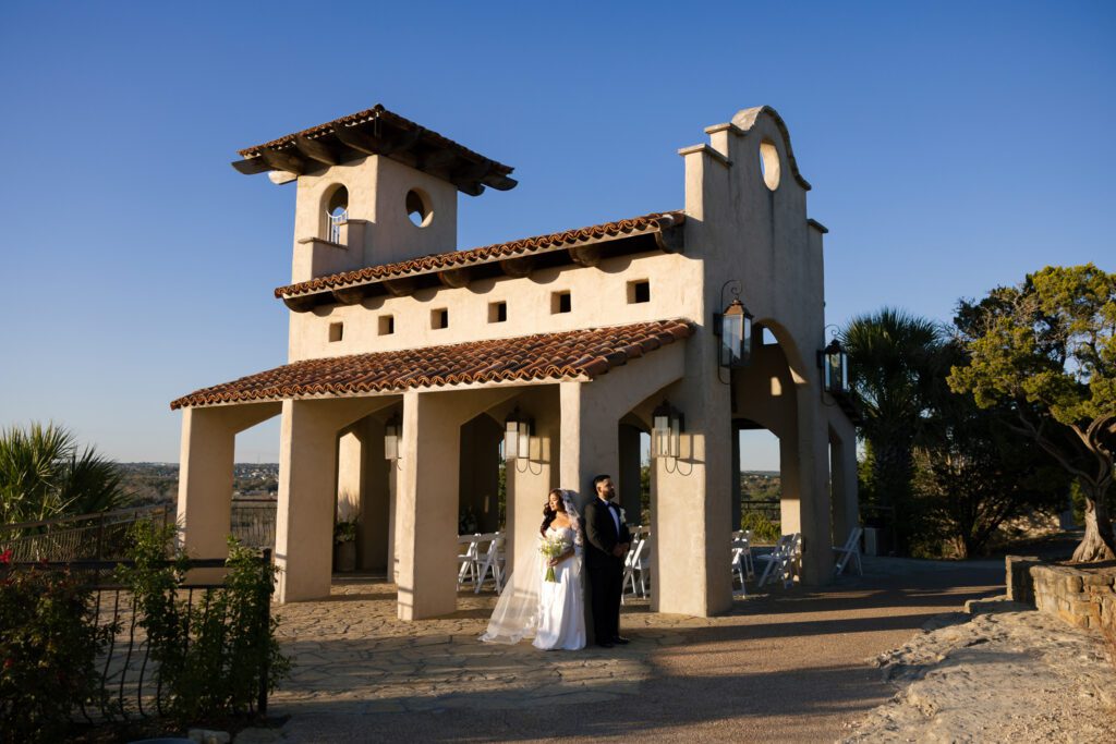 Bride and groom standing outside Chapel Dulcinea in Austin, Texas before their intimate sunset elopement ceremony, photographed by Angie Rich Photography.