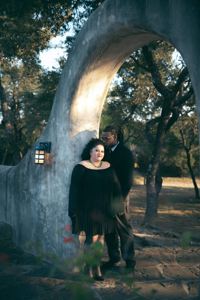35mm film portrait of a couple beneath the iconic stone arch at Lost Mission wedding venue in Spring Branch, Texas, captured during an anniversary session by Angie Rich Photography.